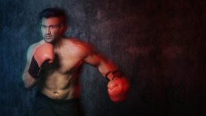 Muscular male boxer with the red boxing gloves