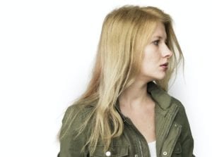 Blonde young woman studio portrait