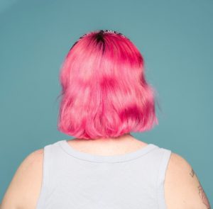 back of plus sized woman with pink hair