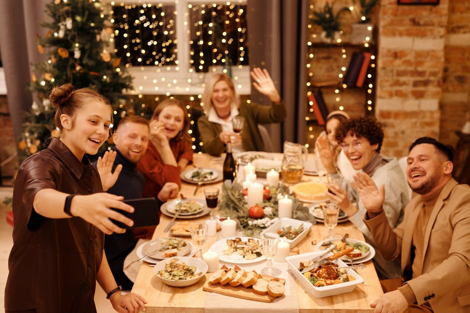 family at the holiday table taking a selfie
