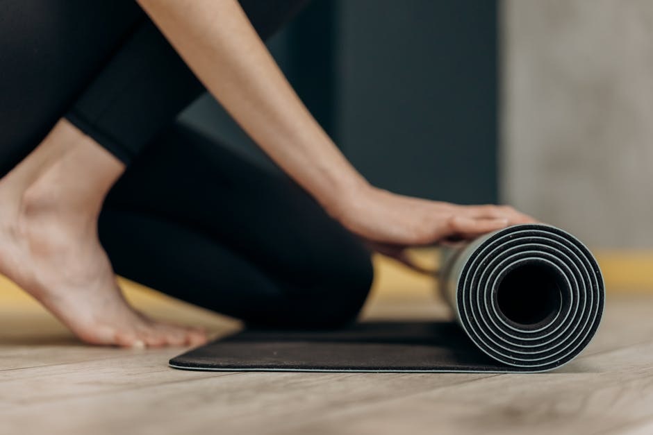 woman unrolls fitness mat