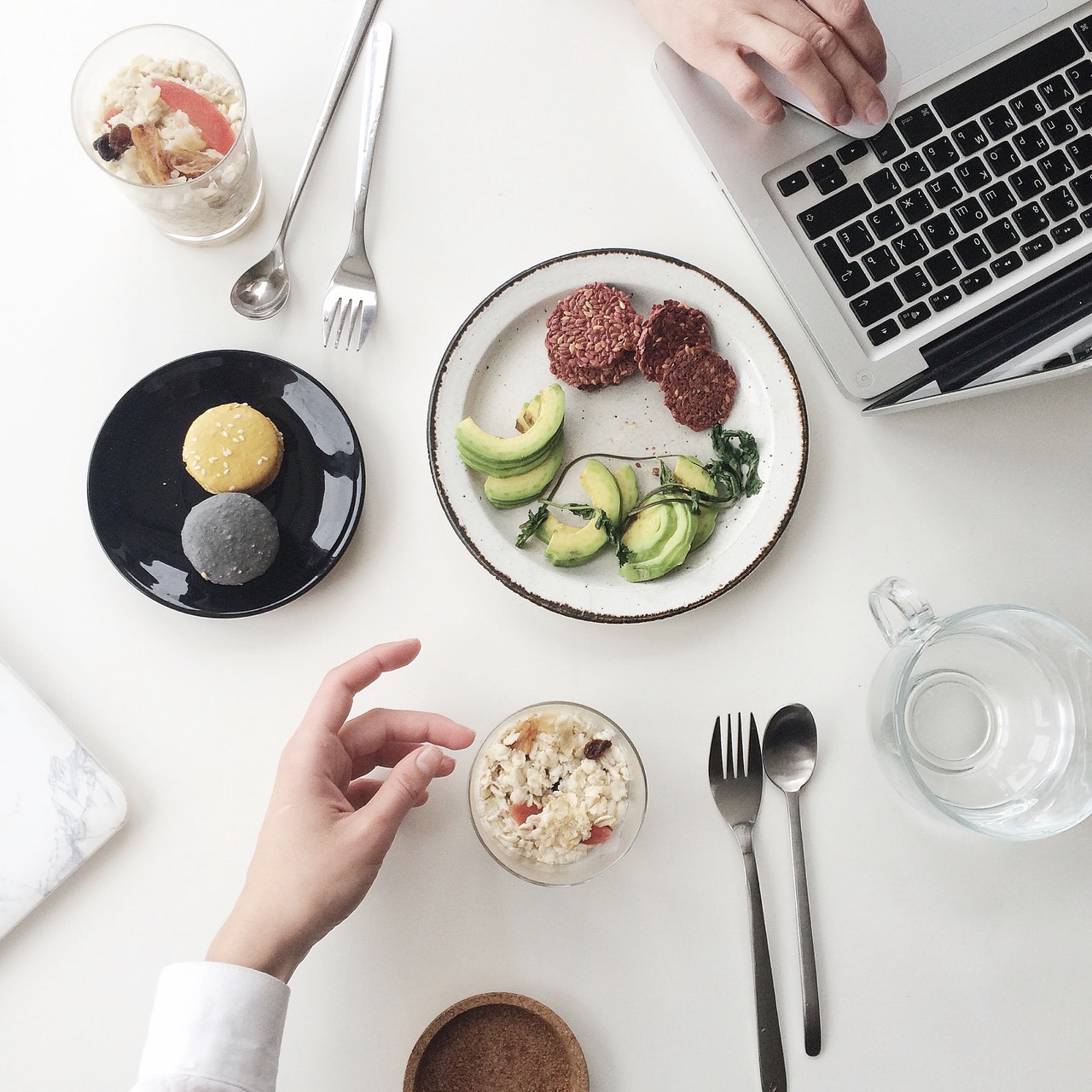 Top view of healthy food and a laptop in a white table