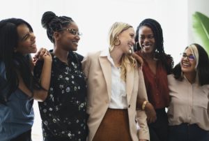 group of women hugging and smiling